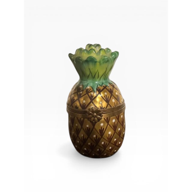 An authentic Limoges porcelain trinket box, hand-painted (Peint Main) and marked “Chamart Exclusive,” crafted in the form...