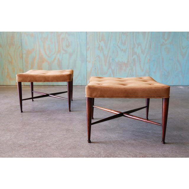 A pair of solid mahogany and thick suede leather Thebes stools / ottomans designed by Edward Wormley for Dunbar. The “x”...