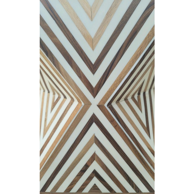A striking handmade Moroccan stool crafted from solid wood and resin, featuring an intricate geometric design that feels...