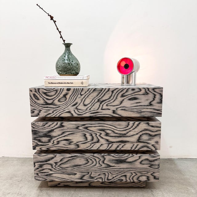 This vintage 1980s Postmodern dresser is a striking statement piece featuring three stacked drawers and a clean-lined...