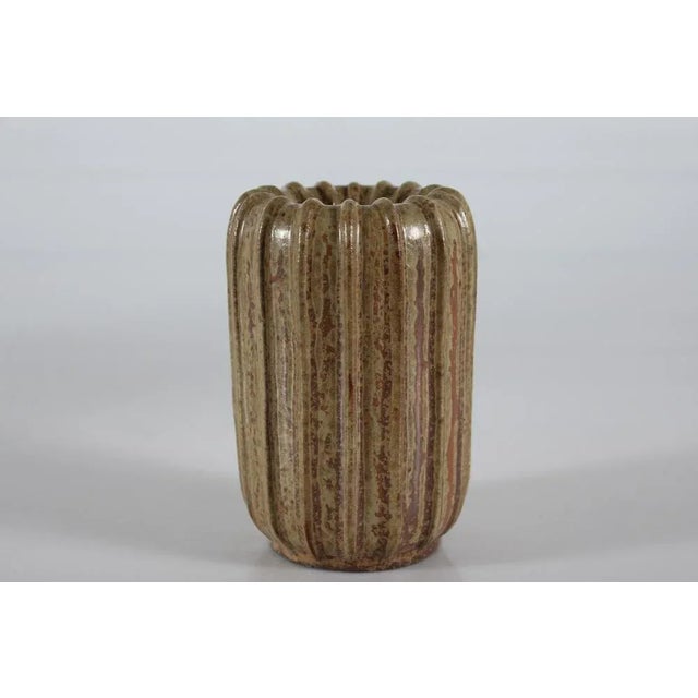 Art Deco slender cylindrical fluted vase by he Danish ceramist Arne Bang (1901-1983). The vase is decorated with speckled...