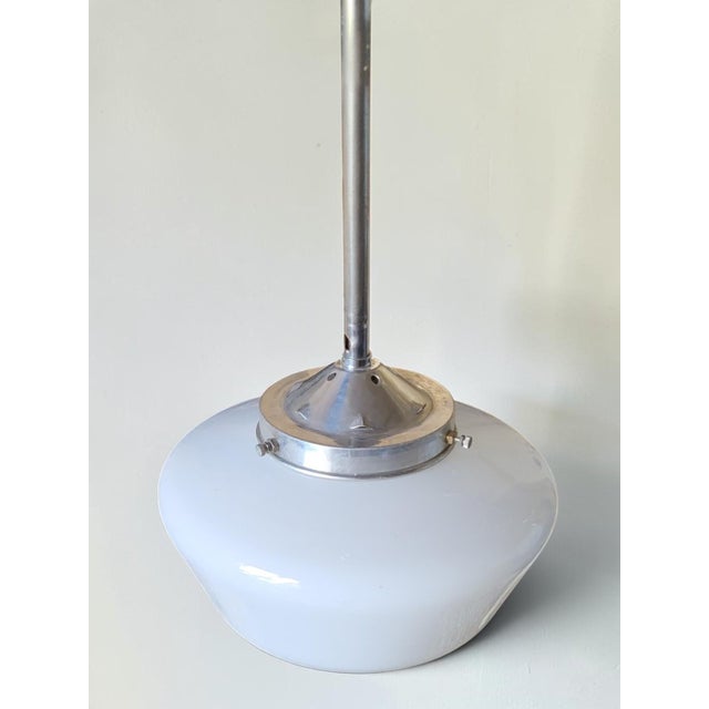 Vintage pendant light with a white opaline glass shade. Height 69 cm Diameter 28 cm In good condition / signs of wear and...