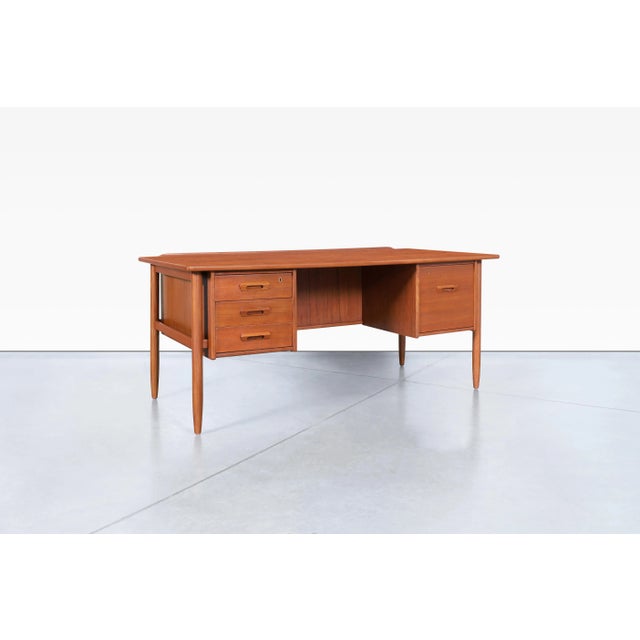 An exceptional example of Swedish modern design, this Model 15 executive desk was designed by Goran Strand for Lelangs...