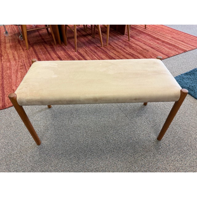 Danish Modern teak upholstered bench designed by Niels Otto Moller for J L Moller, Denmark. The bench is upholstered in a...