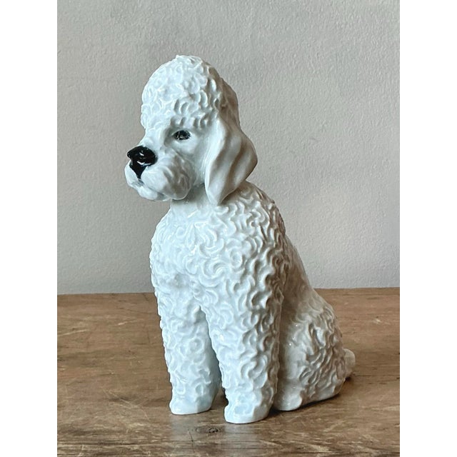 This charming ceramic poodle figurine embodies the playful sophistication and animal fascination popular in mid-century...