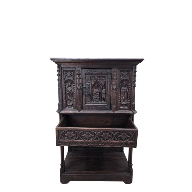Antique French Gothic Revival Carved Oak Cabinet with Religious Figures An extraordinary late 19th-century French Gothic...