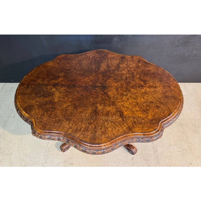 A truly wonderful mid 19th Century Burr Walnut Centre Table. Supported on a rare ‘basket’ base, lovely carved edge to the...