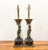 A whimsical pair of vintage table lamps featuring hand-painted jesters dressed in classic black-and-cream harlequin...