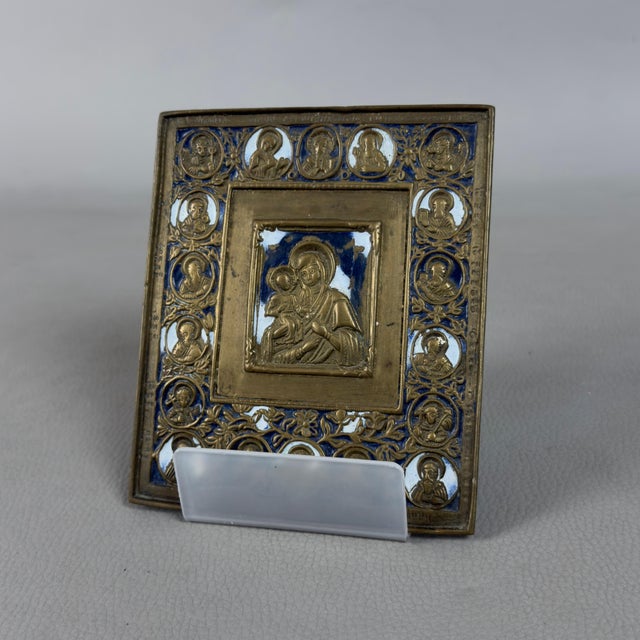 A rare and exquisite devotional object in brass and glass enamel depicting the Madonna and Child, complete with a acrylic...