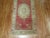 One of a kind, mid 20th-century Hand-knotted Turkish Wool Runner with 3 medallions on a soft red field. Professionally...