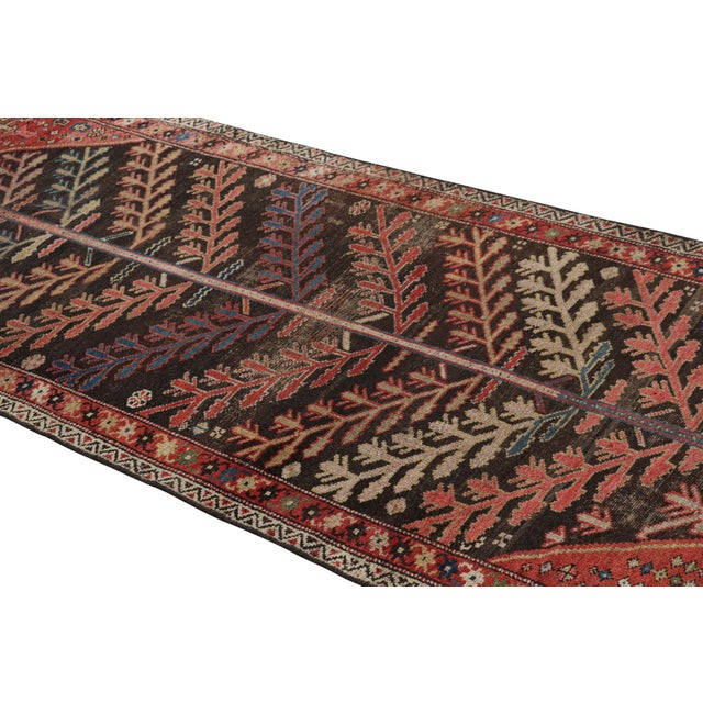 Hand-knotted in wool circa 1910-1920, this 3x8 antique Persian runner rug is a rich and exciting new curation from Rug &...