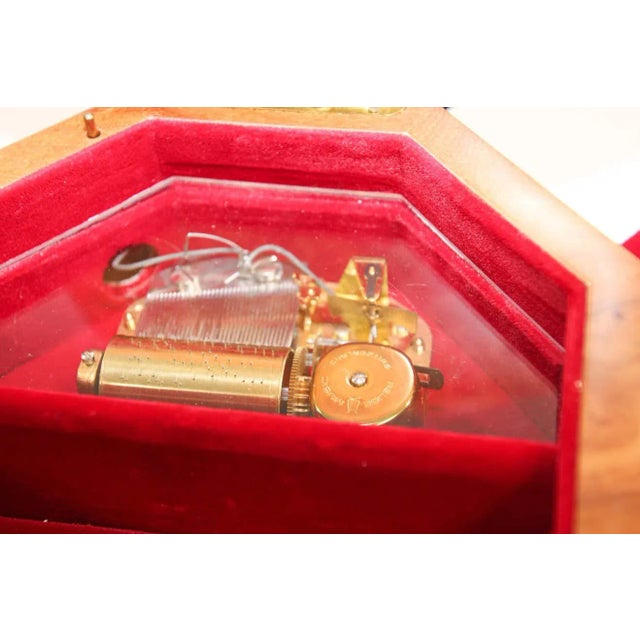 Elegant octagonal wooden music box in thuya wood. Thuya tree is famous for rich gold and brown shades of its grain and...