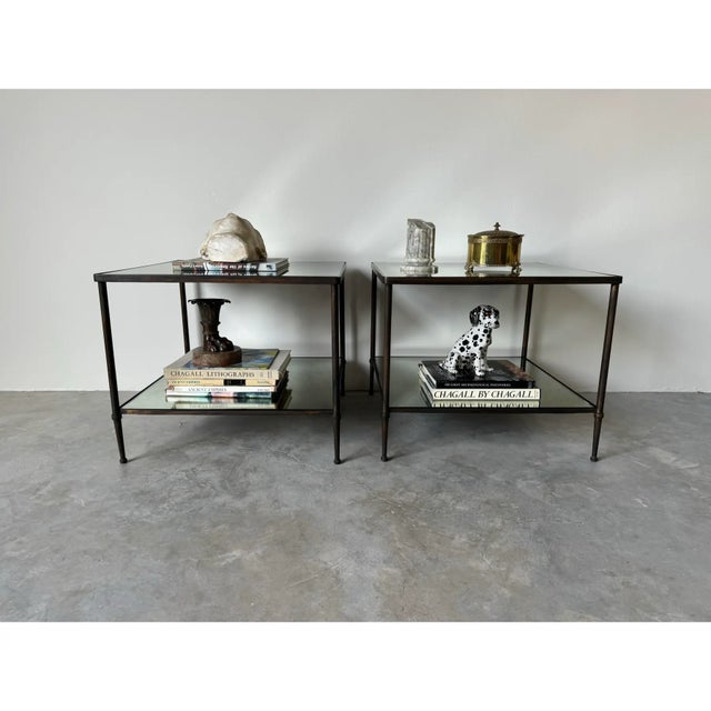 We are delighted to offer for sale this stunning pair of Vintage Hollywood Regency style two - tier bronze frame and glass...