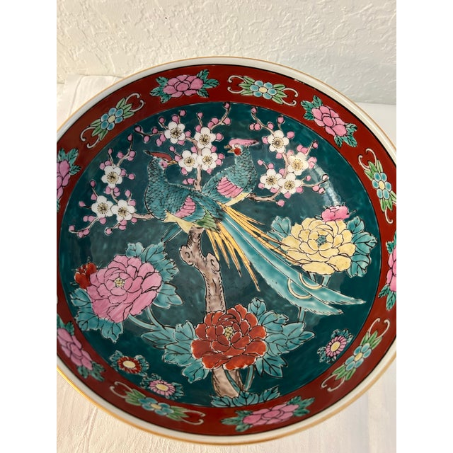 Gorgeous, generous size, mid-century Imari bowl featuring a pair of Pheasants perched on a branch surrounded by a floral...