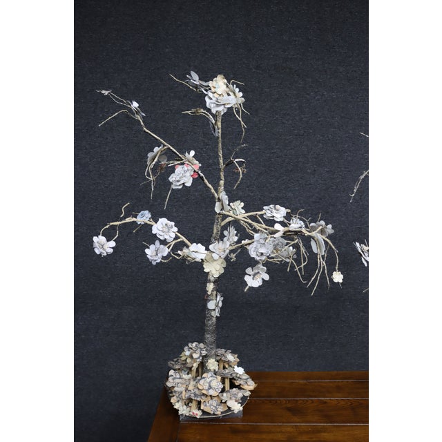 Pair of decorative paper mâché tree sculptures featuring hand-formed branches and layered flowers made from book pages and...