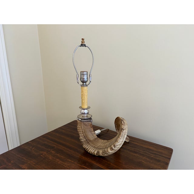 A striking vintage table lamp crafted from a natural ram’s horn, offering a sculptural and textural presence that...