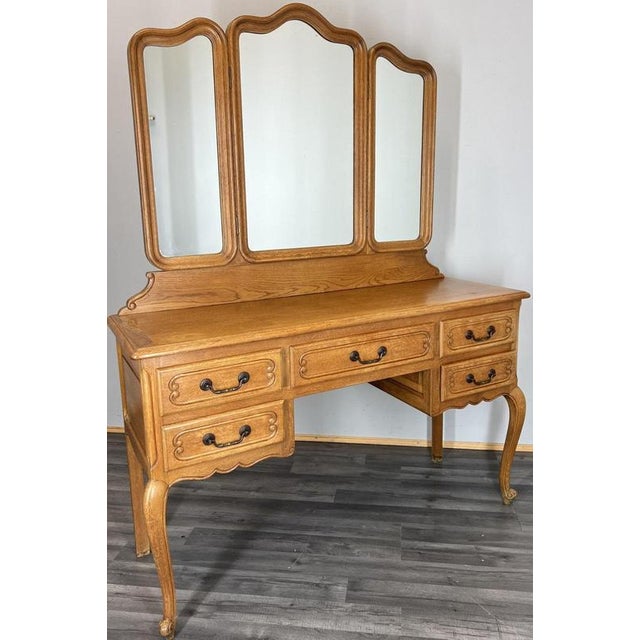 A beautifully crafted Vintage French Louis dressing table in solid oak, featuring graceful carved lines, elegant cabriole...