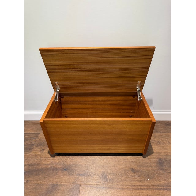 A beautifully minimalist Danish Modern teak blanket chest or storage trunk, showcasing the clean lines and refined...
