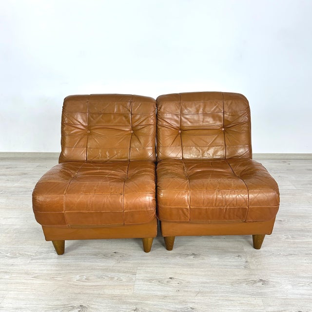 Dimensions: H 31” x W 25” x D 31” x SH 18.7” Pair of Vintage Italian lounge chairs in cognac leather patchwork from the...