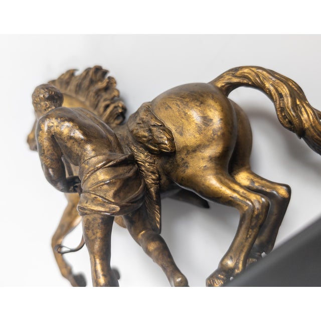 We are selling this 19th century French bronze after Marly Horse. This bronze of a man restraining a rearing horse is...