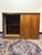If you are looking to ground your space with some authentic mid-century warmth, this teak finish, sliding door cabinet is...