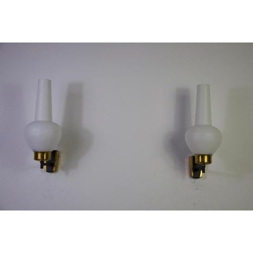 This elegant pair of mid-century wall lamps was produced in italy during the 1960s and reflects the refined balance of...