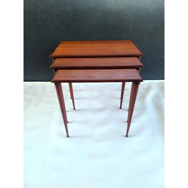 Lovely solid Teak Danish Nesting table trio by Vejla Stolefabrik Denmark. Very elegant design with attractive ball foot...