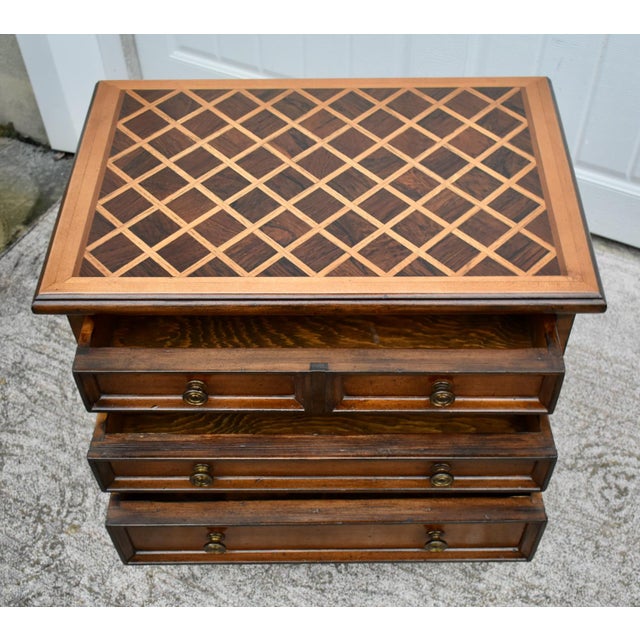 Vintage (1960's) Small Chest has a french Louis X111 Style. The Chest has a Parquet Top, Three Drawers, and Bun Feet. The...