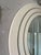 A beautifully proportioned Italian wall mirror defined by its bold, concentric frame and soft architectural presence. The...