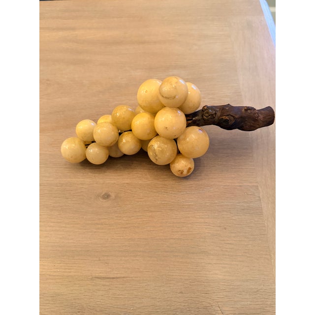 Carved alabaster grape cluster from the 1970s. They are attached to a real piece of grape vine. Though they are not marked...
