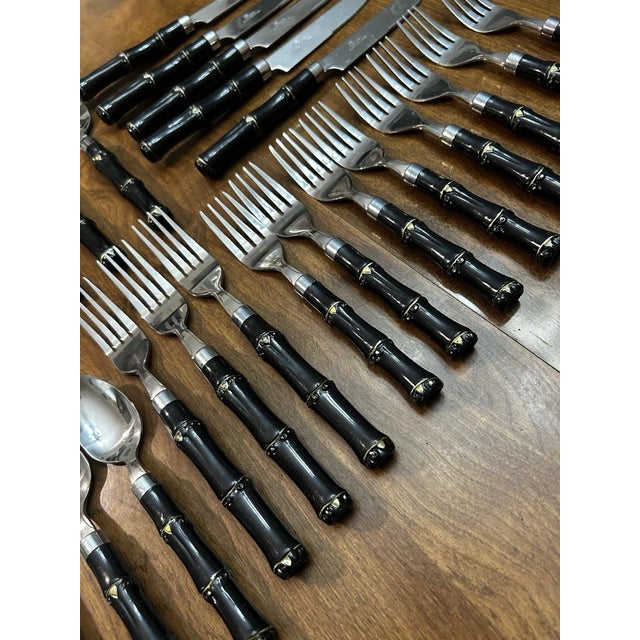Add a touch of classic mid-century style to your table with this 28-piece Gibson faux bamboo stainless steel flatware set....