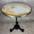 Parisian bistro pedestal table, white marble top set with embossed brass. Lion-shaped cast iron base and wrought iron feet.