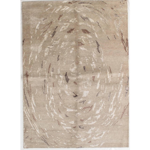 Hand-knotted modern rug featuring an abstract composition with soft, organic movement across the field. The design is...