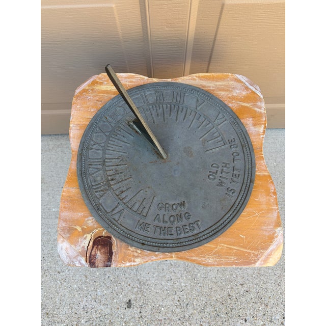 A classic vintage iron verdigris garden sundial inspired by traditional English estate landscapes, reading "Grow old along...
