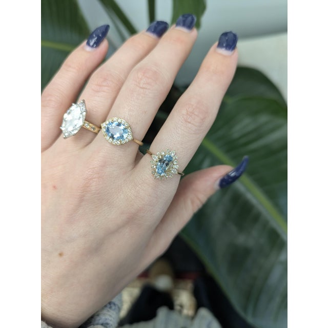 Crisp aquamarine in a 9×7 mm oval set in rich 14K gold with dazzling natural diamond accents.Chic and serene...