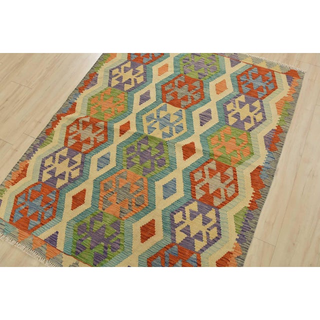 This tribal geometric Kilim rug is handwoven with all wool on a wool foundation. This rug is new and in excellent...