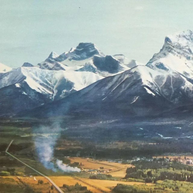 A countrycore vintage pull-down wallchart poster showing a highway with the Canadien Rocky Mountains in the background,...