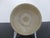 Chinese Longquan style small celadon pottery bowl. Small tea bowl with thick green-gray tone glazed pottery with unglazed...