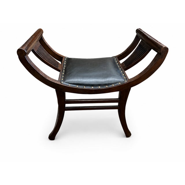 his vintage saddle bench or stool features a beautifully curved dark wood frame with rolled side supports, open slatted...