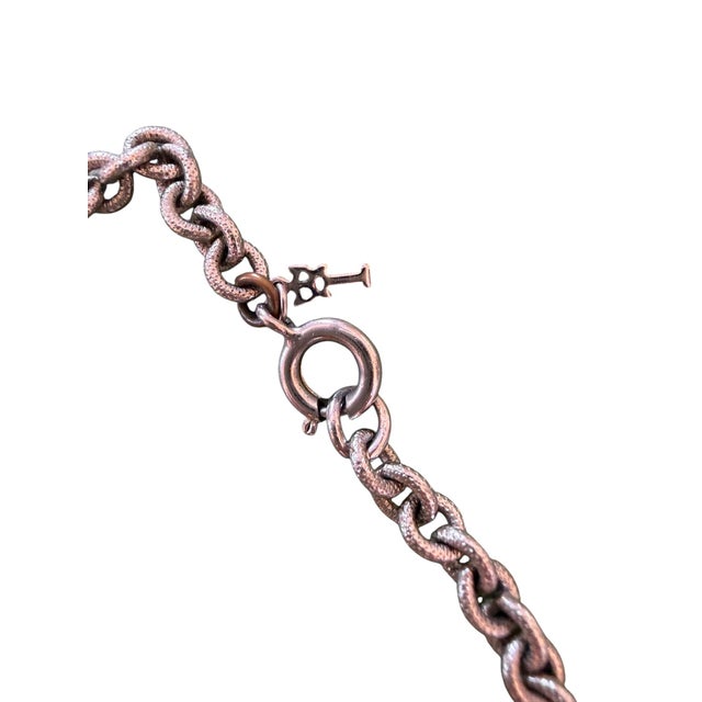This is a vintage Crown Trifari Modernist swirl pendant necklace featuring an intricate openwork scroll design on a...
