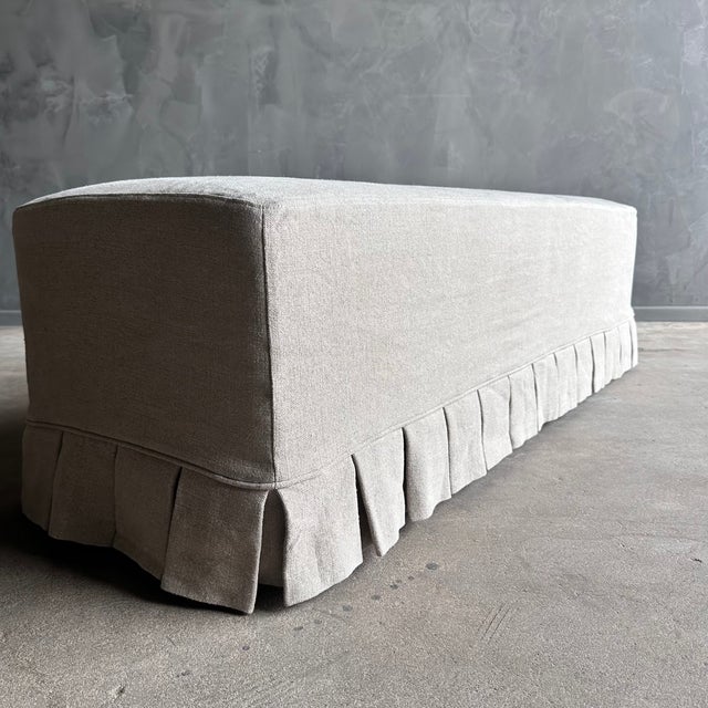 Introducing the April slip covered bench, featuring elegant white oak legs and a slip cover with a wide pleated skirt made...