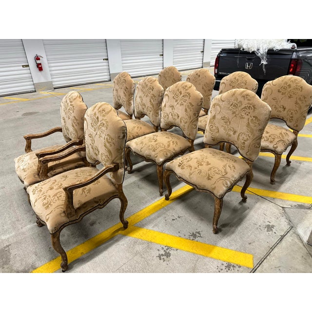 I have 2 arm chairs and 8 side chairs available. They are upholstered in a Nomi velvet fabric with gold hand painting.