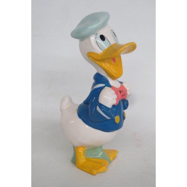 This adorable Donald Duck Figurine is made out of earthenware clay ceramics. This lovely little piece was made by Dan...