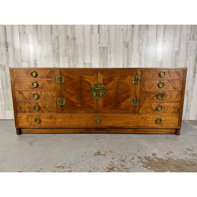 Classic Edward Wormley for Dunbar mahogany credenza with solid brass hardware. Nine drawers with center cabinet.