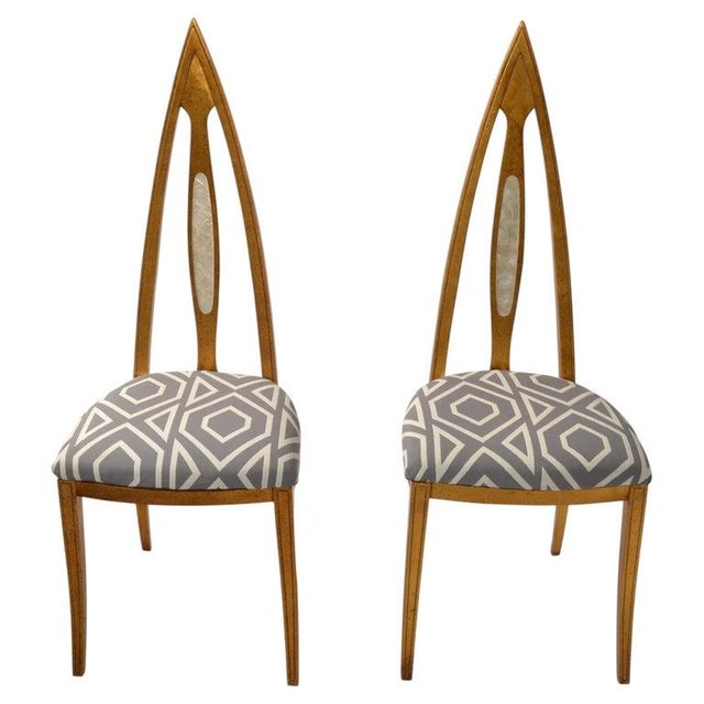 A pair of American distinctive high-back chairs with an elongated, pointed backrest design by John Turano & Sons. The...