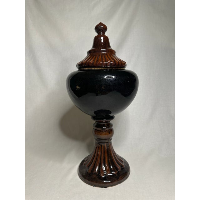Rich colors of chestnut brown and ebony black adorn this crackled glazed ceramic urn. It's large size is impactful with a...