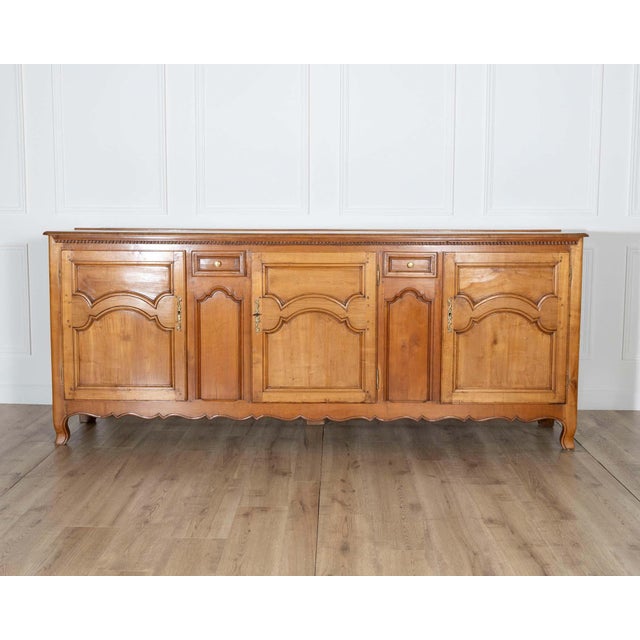 A handsome 19th-century French enfilade crafted from richly grained cherry wood, combining generous storage with refined...