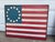 A vintage Americana wooded American flag. Besty Ross American flag. Beautiful wall hanging. Ready to hang! Made of wood.