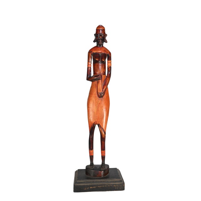 A rare and visually striking set of hand-carved African wooden figures originating from East Africa, likely dating to the...