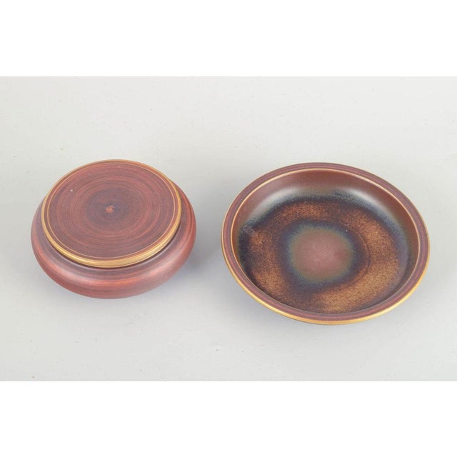 Gunnar nylund for alp, lidköping lidded bowl and dish, 1960/70s. Hand-thrown ceramic set consisting of a lidded bowl and a...